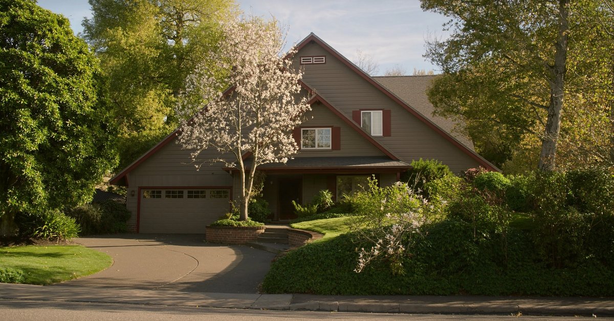 Auburn Washington real estate market 2026 -- suburban home with green lawn representing home values and investment opportunity in King County