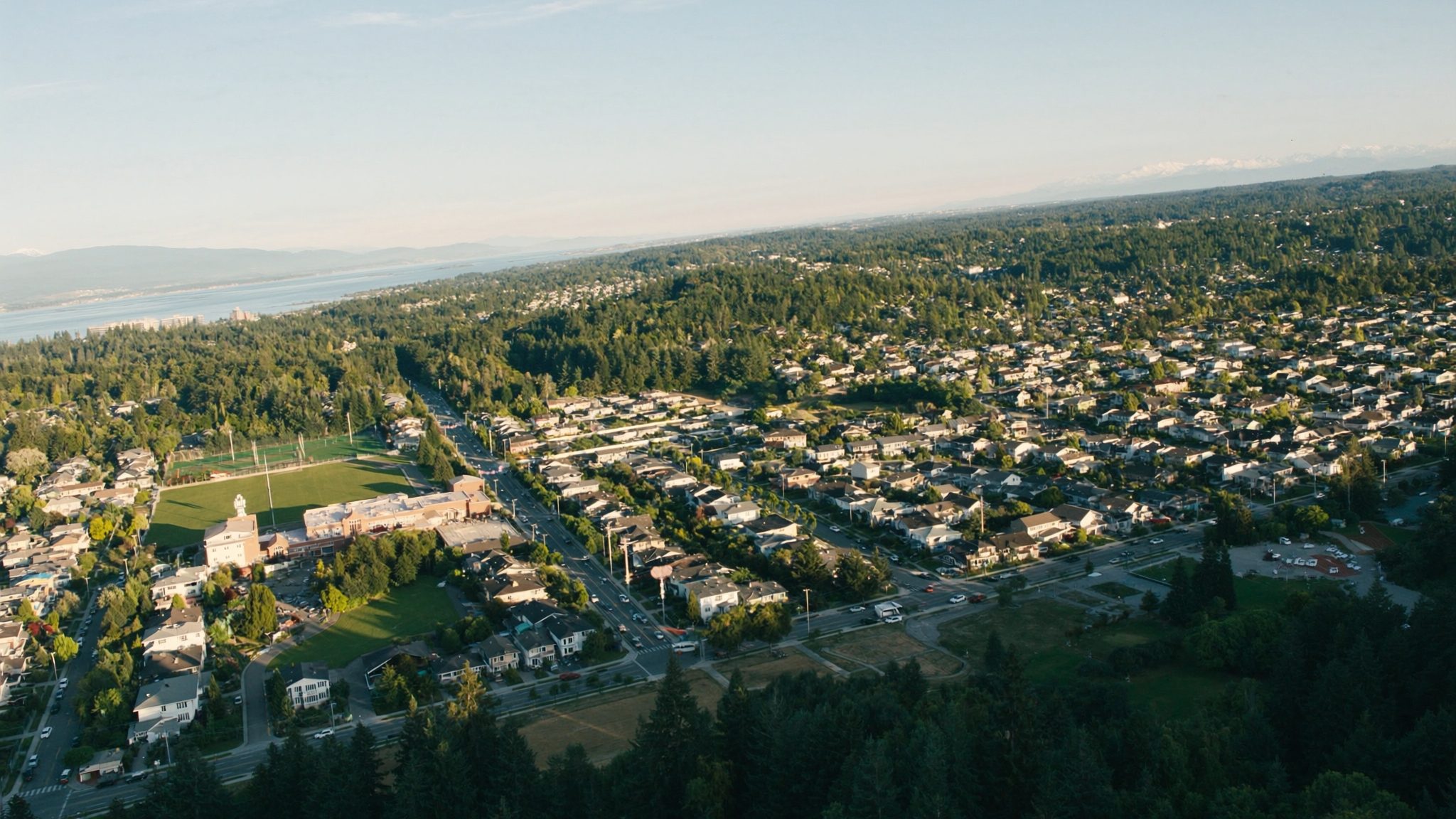 Aerial view of Federal Way Washington neighborhoods with Puget Sound and Olympic Mountains visible in the background