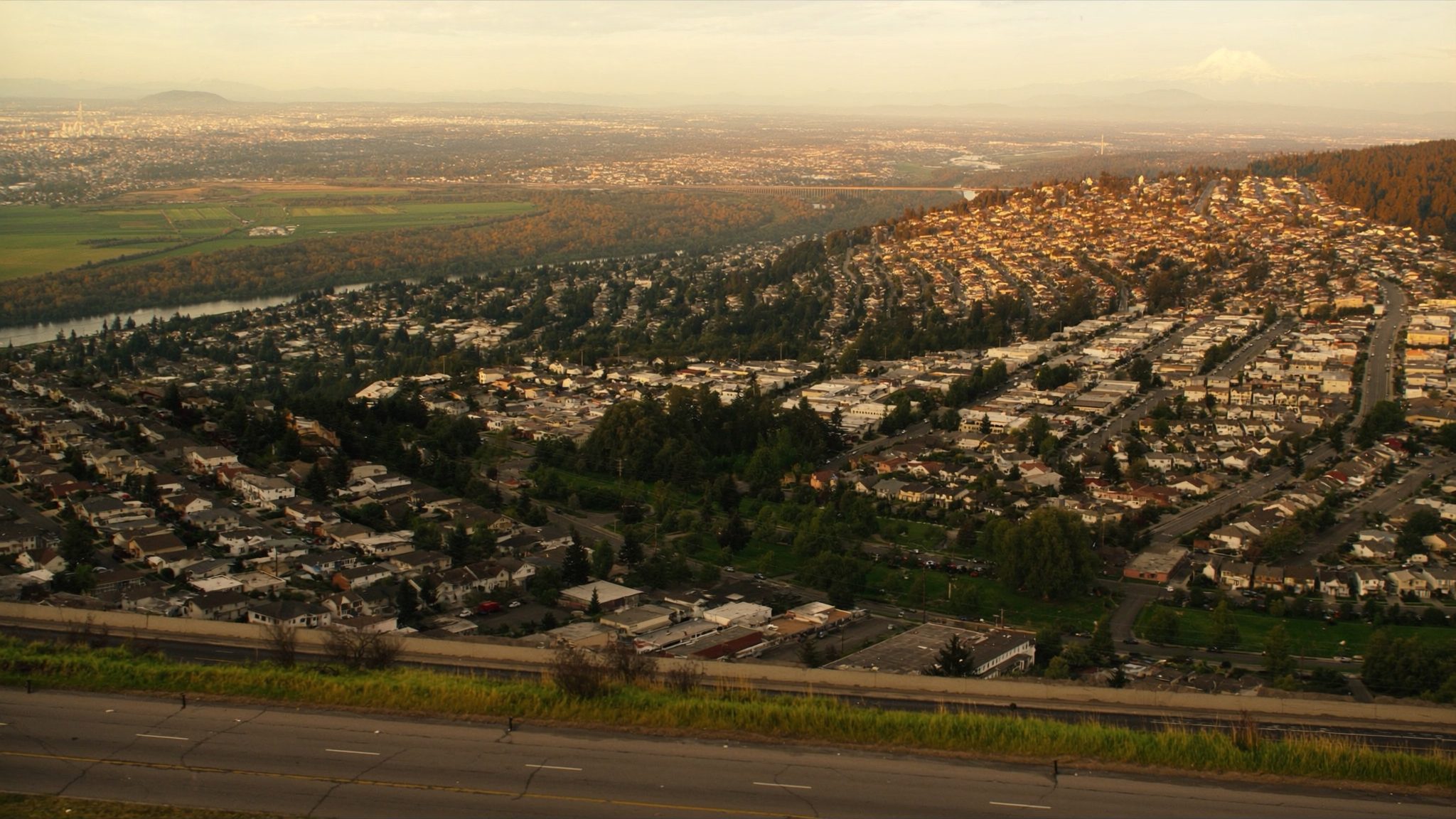 Panoramic aerial view of Kent Washington neighborhoods in King County with Green River valley and Mount Rainier in the background