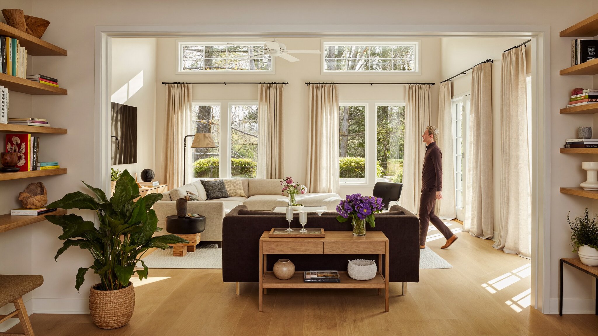 Homeowner walking through staged King County home interior with warm Pacific Northwest lighting for spring 2026 home sale