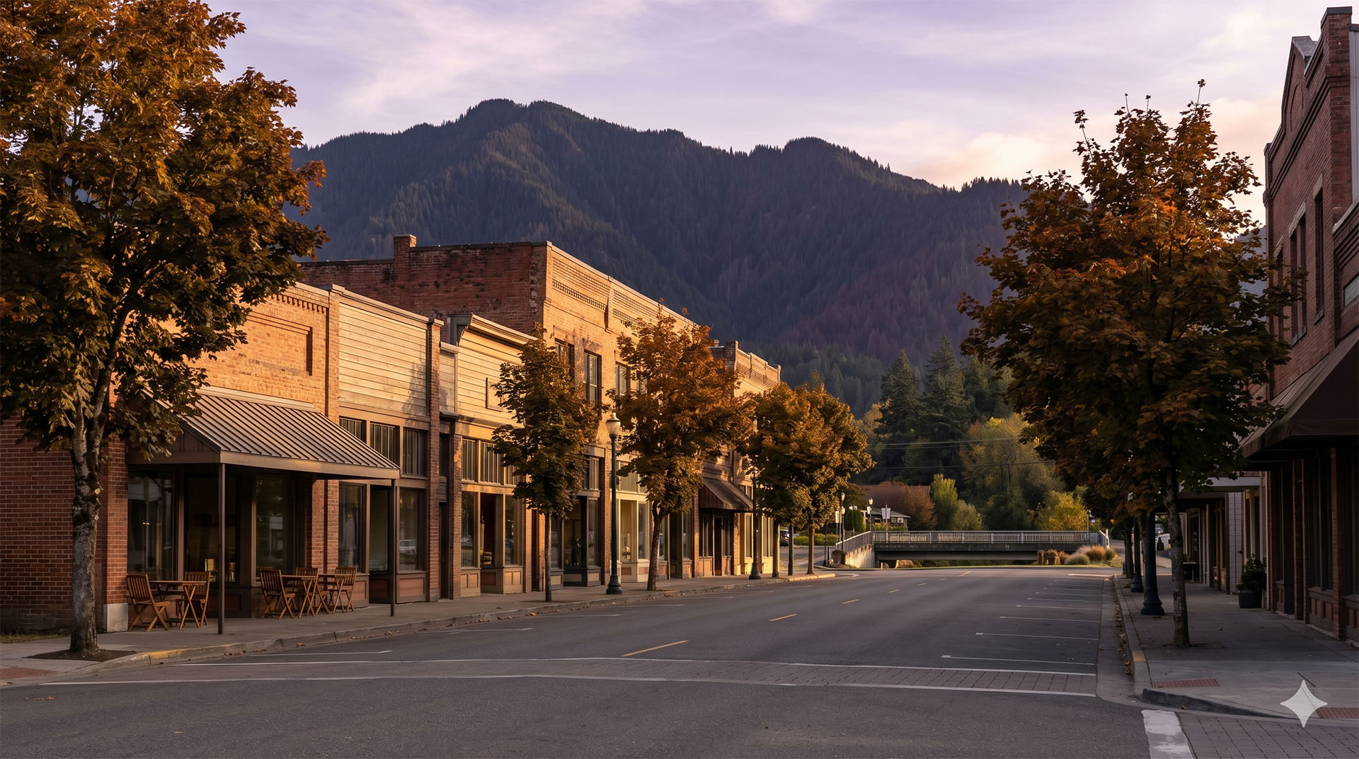 Front Street in historic Olde Town Issaquah at golden hour, with mature street trees and restored storefronts, King County, Washington.