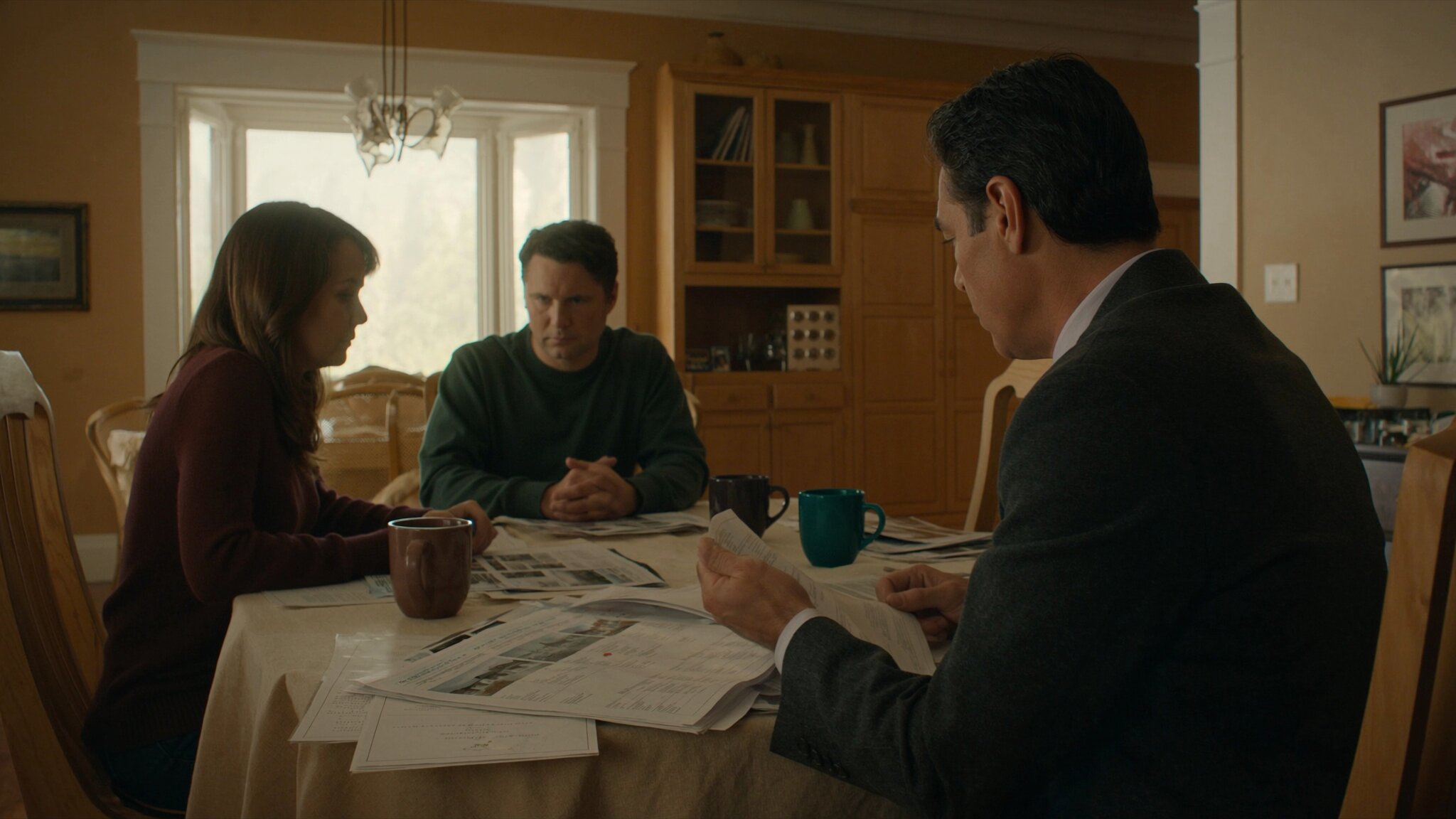 Real estate agent reviewing total homeownership costs with first-time buyer couple at kitchen table in King County Washington home