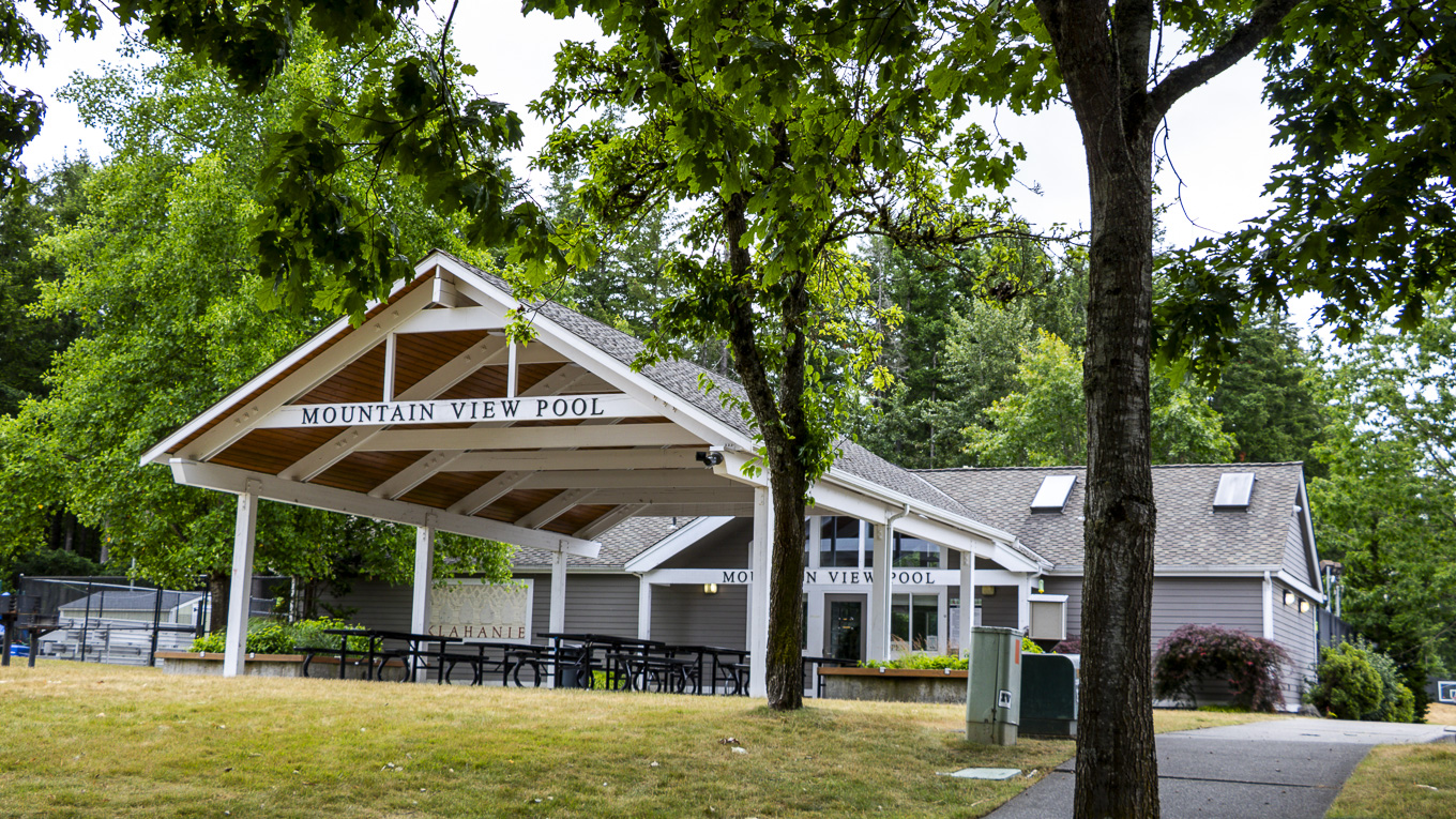 Community clubhouse and outdoor amenity area in Klahanie, Sammamish, Washington with mature landscaping and Pacific Northwest architecture