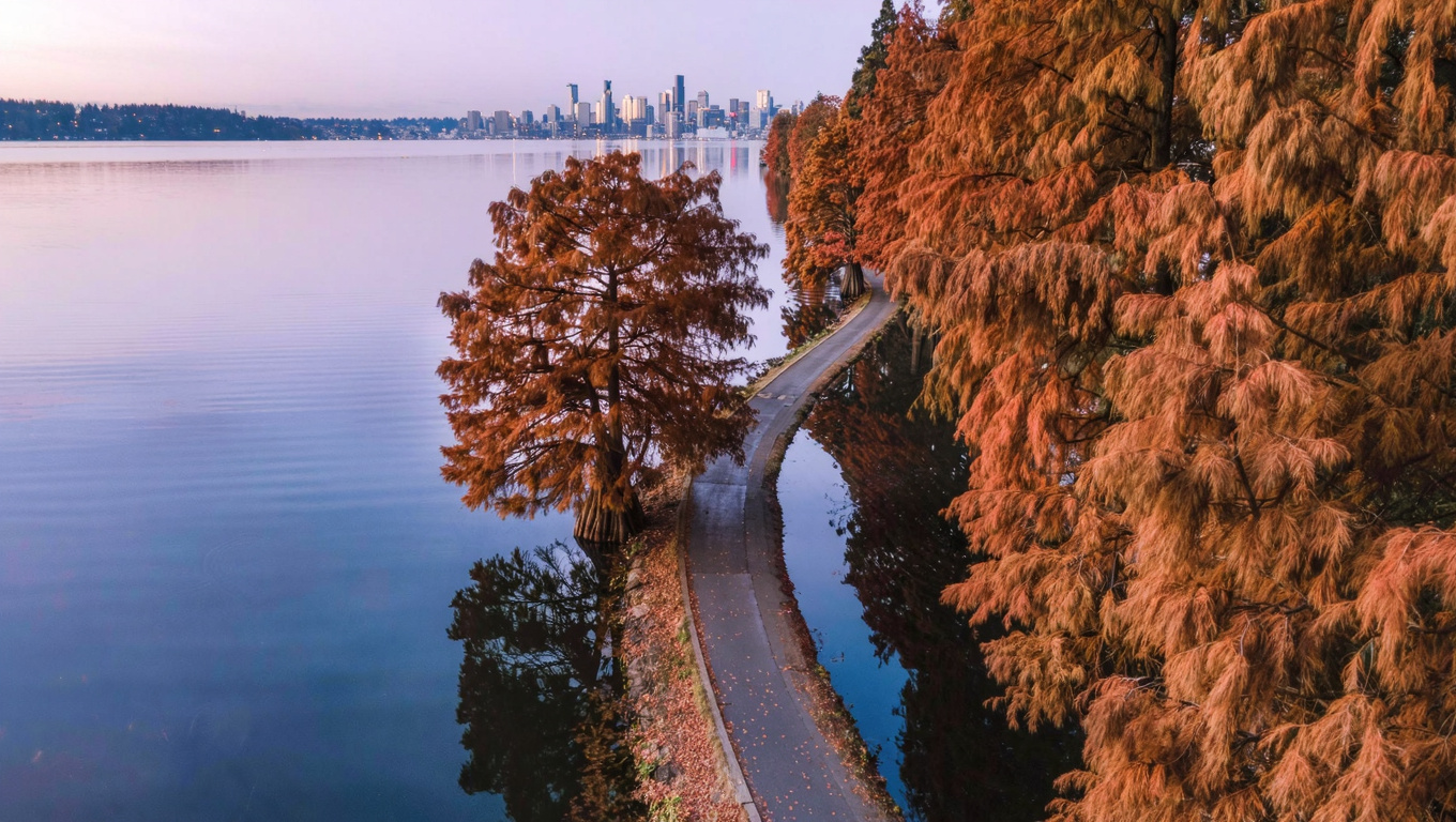 Cedar River Trail paved path through Cascade neighborhood of Renton Washington, flat trail along Cedar River with mature riparian trees.