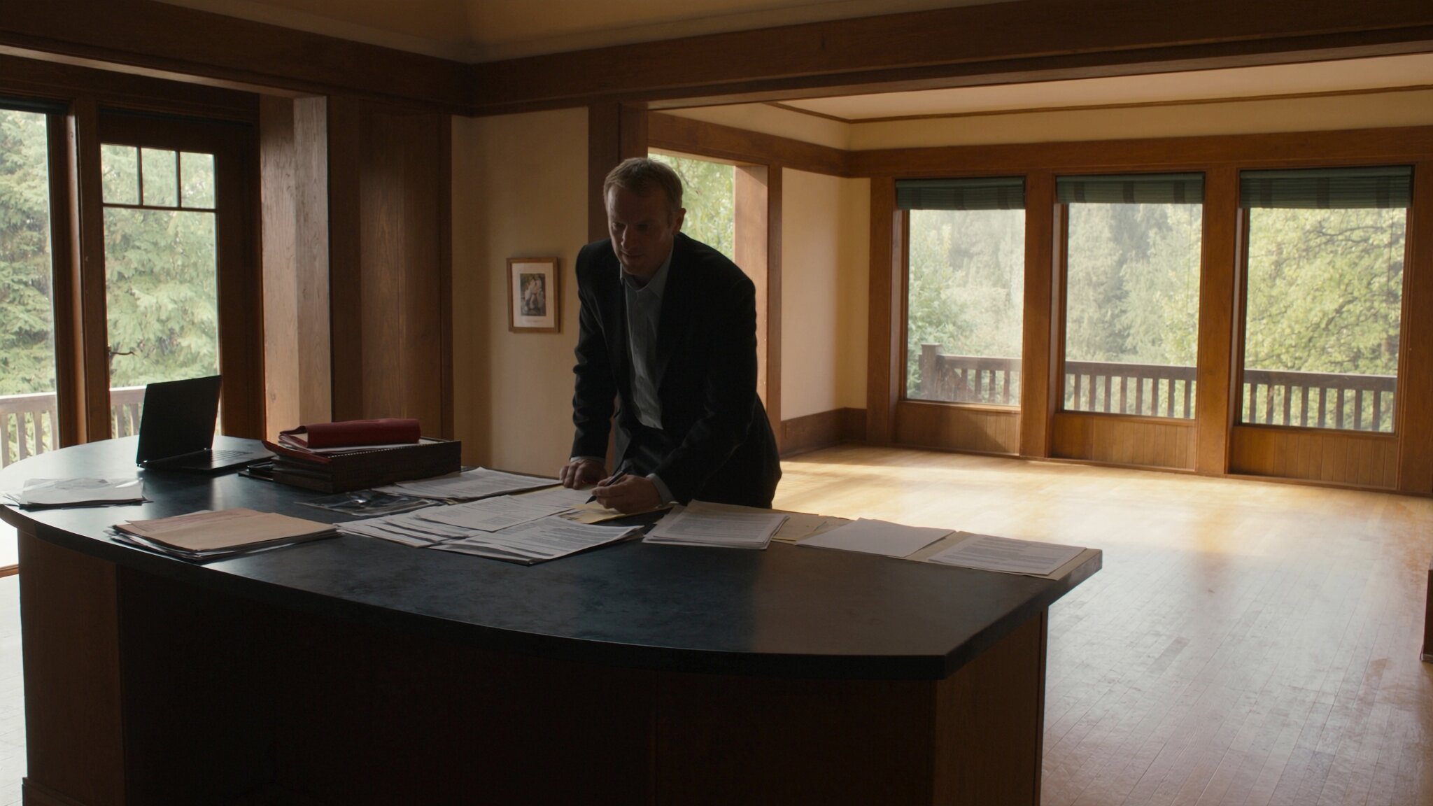 Couple reviewing real estate documents at kitchen table in Pacific Northwest home — contingent offer King County -->