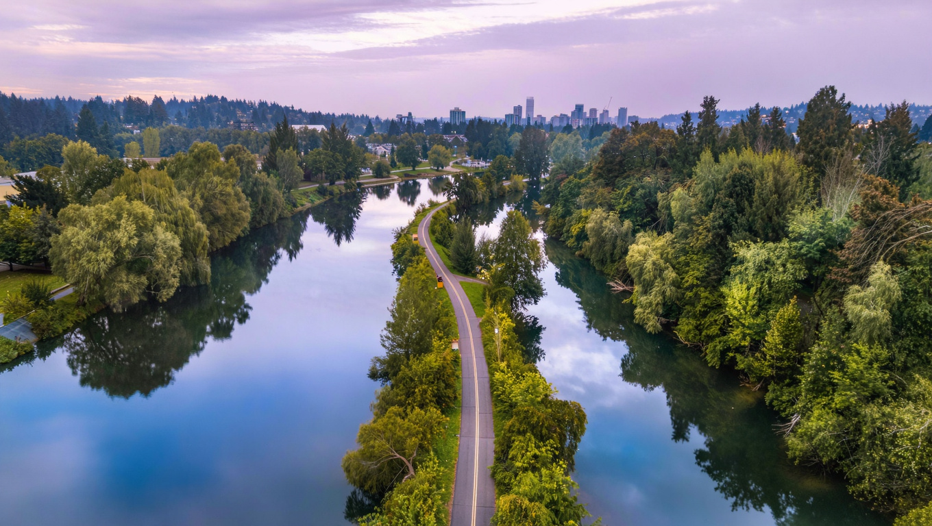 Cedar River Trail paved path winding through riparian forest alongside the Cedar River in Downtown Renton, Washington.