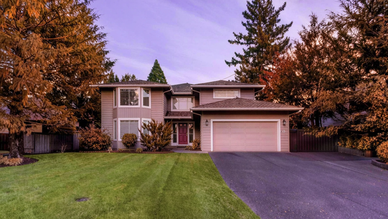1980s to 2000s two-story Pacific Northwest single-family home exterior in East Renton Washington with attached garage on a cul-de-sac lot.