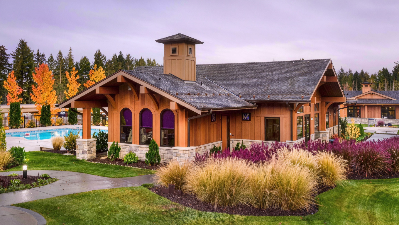 Community clubhouse and outdoor amenity area in Klahanie, Sammamish, Washington with mature landscaping and Pacific Northwest architecture