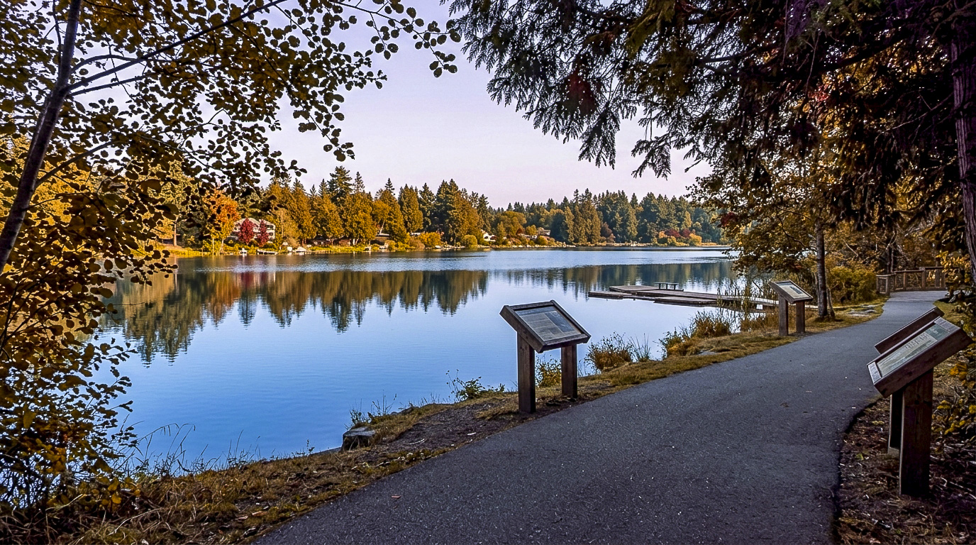 Walkers on the paved trail loop around Panther Lake in Kent, Washington