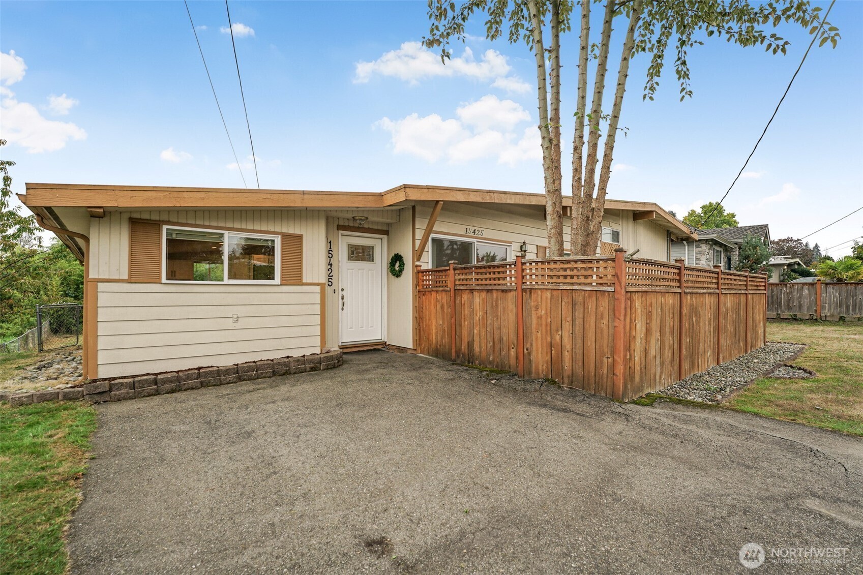 Front of 15425 SE 11th Street, with a fenced front patio and driveway