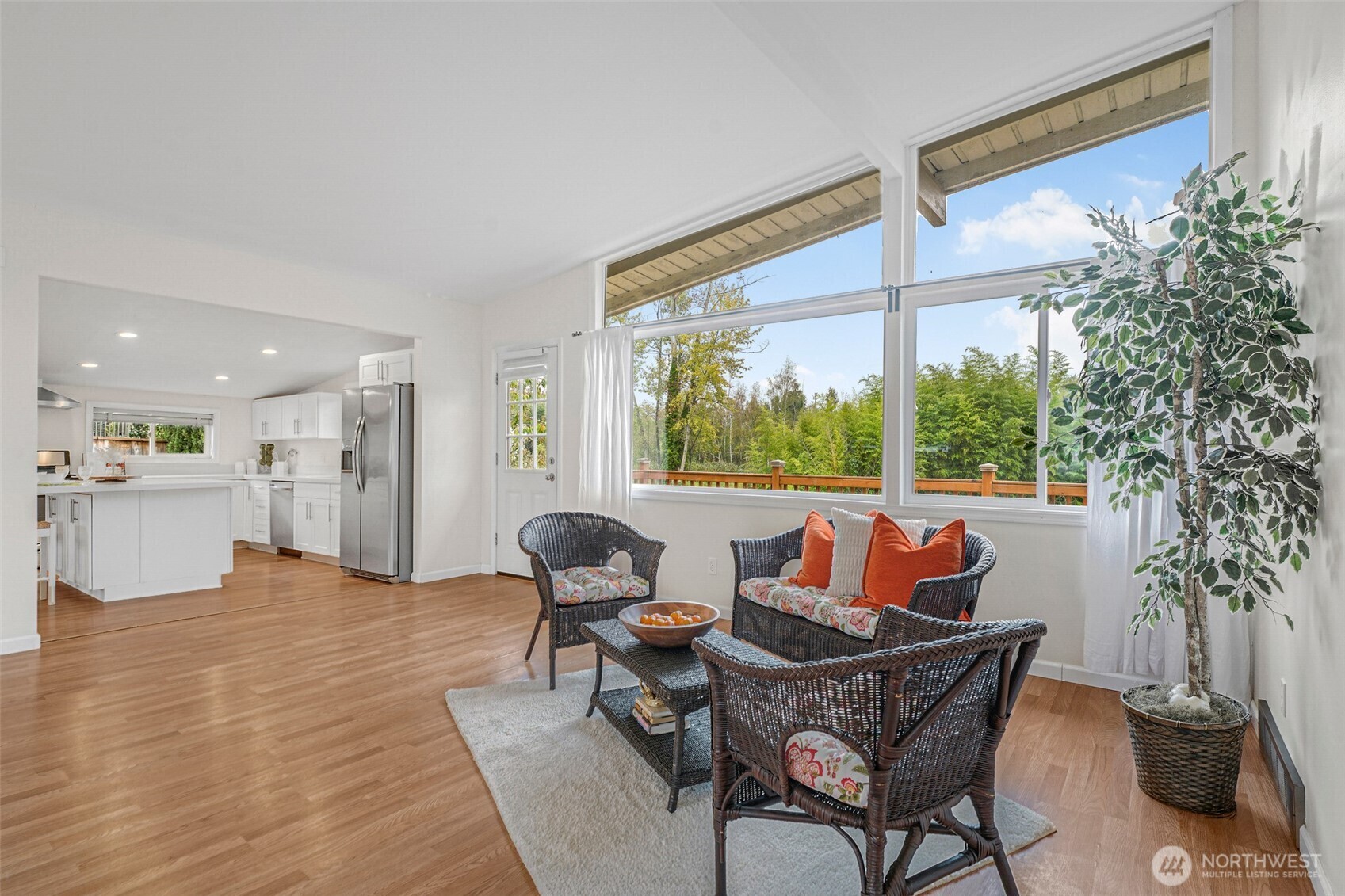 Living room with vaulted ceiling and large picture windows