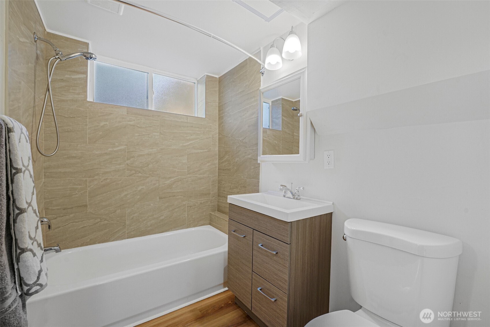 Bathroom with tub and tiled surround