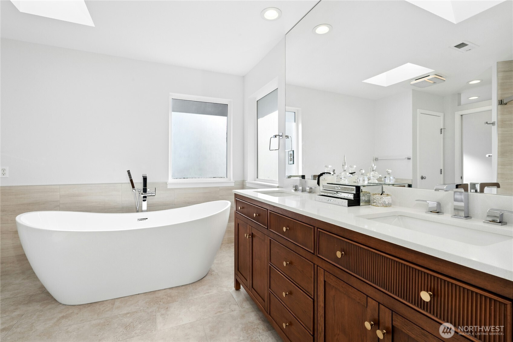 Remodeled primary bath with soaking tub and double vanity