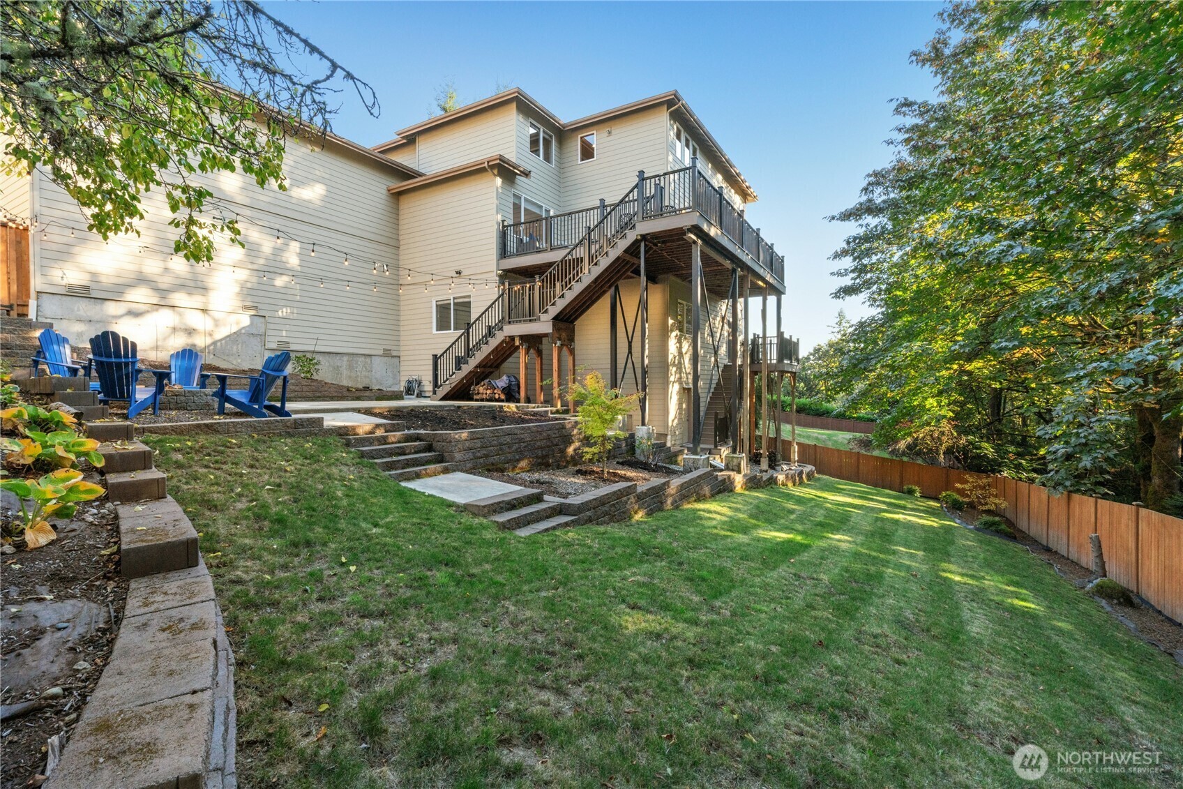 Back of the home with the multi-level deck and yard